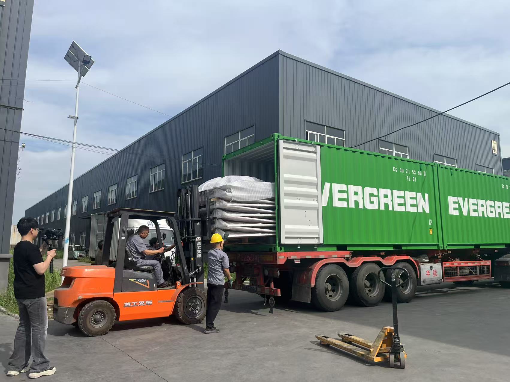 Hydraulic tail lift at a container port ready for shipping