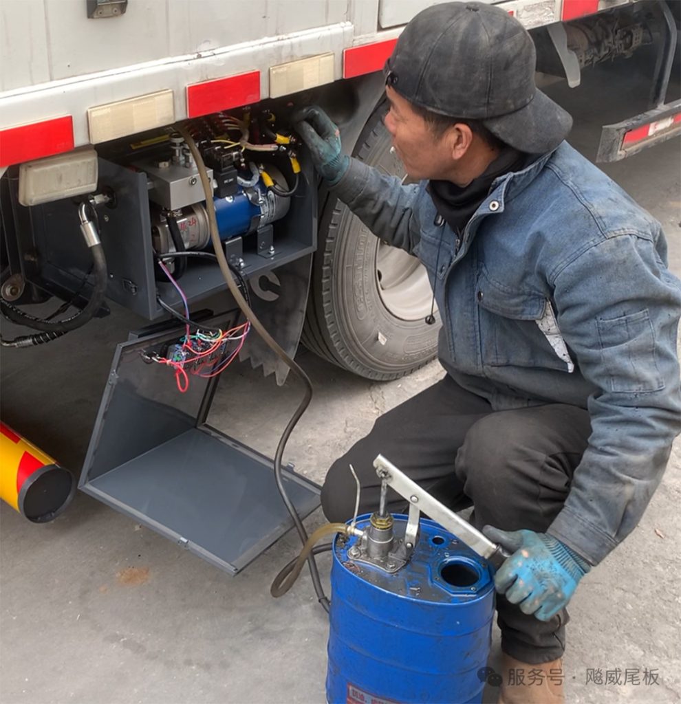Technician inspecting a tail lift with a maintenance checklist to protect warranty coverage