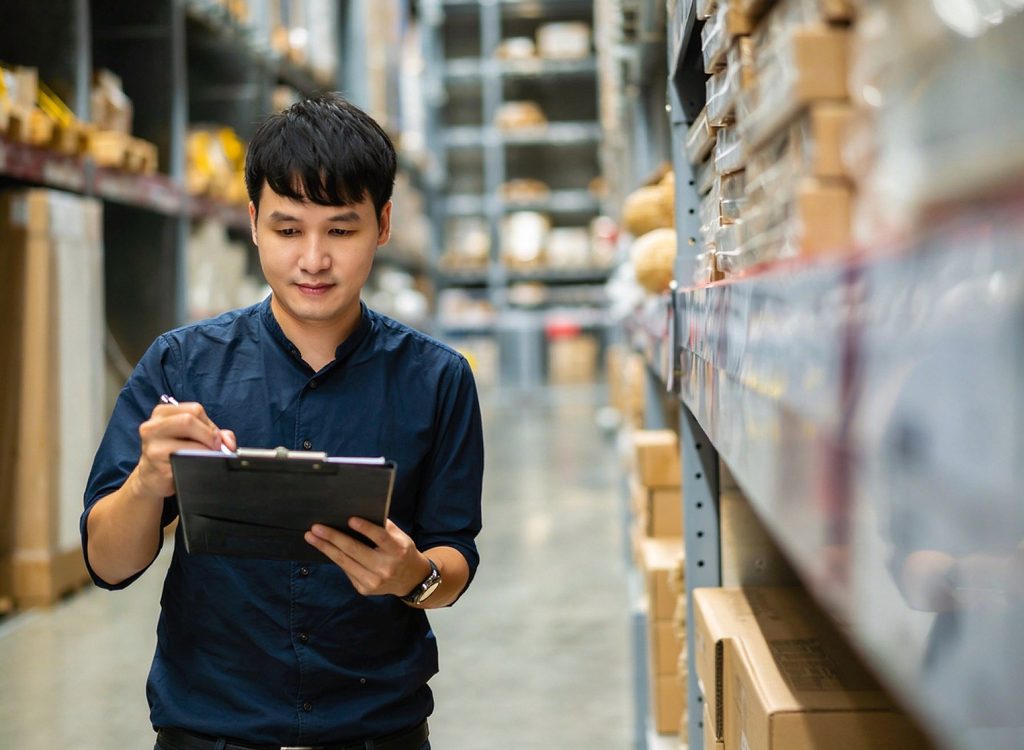 Siam Express Thai logistics manager inspecting cargo operations in a warehouse